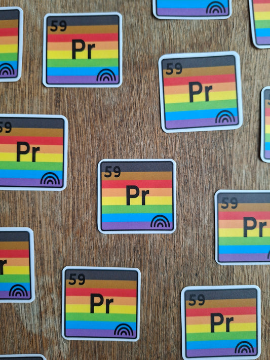 Stickers with rainbow design and text on a wooden surface