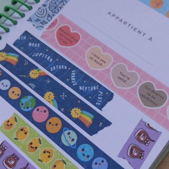 Collection of decorative stickers with various designs on a light surface.